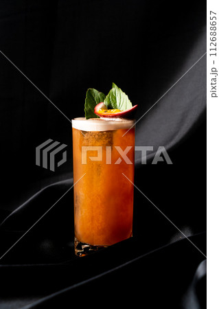 cocktail - infused tequila with basil, passion fruit and cinnamon, lime and mango 112688657