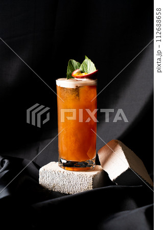 cocktail - infused tequila with basil, passion fruit and cinnamon, lime and mango 112688658