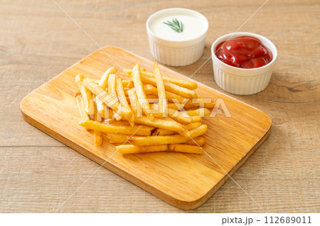 French fries with sour cream and ketchup 112689011