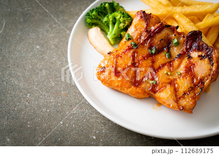 grilled chicken steak with potato chips or french fries grilled chicken steak with potato chips or french fries 112689175