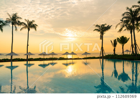 umbrella with bed pool around swimming pool with ocean sea background umbrella with bed pool around swimming pool with ocean sea background 112689369