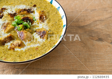 Afghani chicken in green curry or Hariyali tikka chicken hara masala Afghani chicken in green curry or Hariyali tikka chicken hara masala 112689435