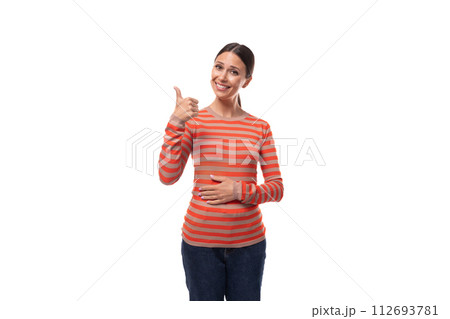 surprised young adult woman dressed in an orange sweater shows like and class with her hands surprised young adult woman dressed in an orange sweater shows like and class with her hands 112693781