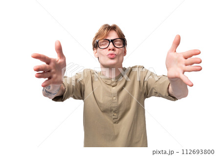 a young loving red-haired European man dressed in a light brown shirt with a tattoo sends an air a young loving red-haired European man dressed in a light brown shirt with a tattoo sends an air 112693800