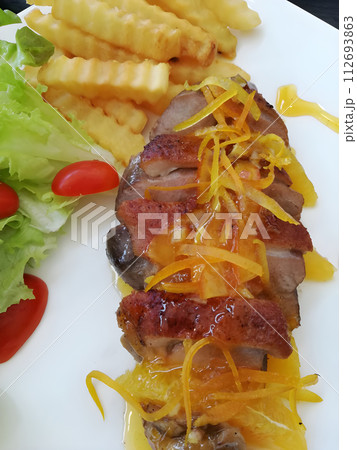Juicy duck confit with orange sauce 112693863