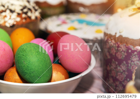 Painted eggs on the Easter holiday table. Easter brunch with eggs and pastries on the holiday table. 112695479