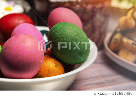 Painted eggs on the Easter holiday table. Easter brunch with eggs and pastries on the holiday table. Painted eggs on the Easter holiday table. Easter brunch with eggs and pastries on the holiday table. 112695480