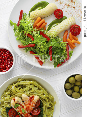 Boiled squid with baby carrots and lettuce, tomatoes and pea puree. Keto diet. 112696161