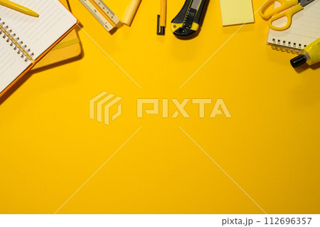 School supplies on yellow background. Flat lay, top view with copy space School supplies on yellow background. Flat lay, top view with copy space 112696357