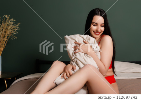 Photo portrait of dreamy girl hugging pillow on 112697242