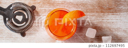 Orange drink with ice, panorama, overhead flat lay shot Orange drink with ice, panorama, overhead flat lay shot 112697495