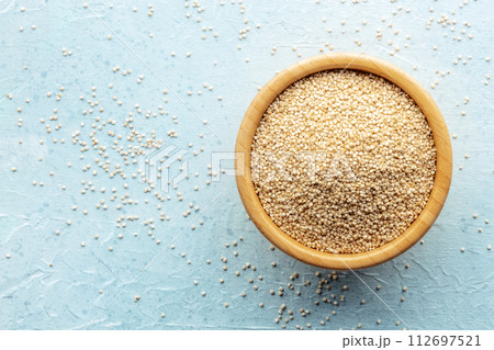 Quinoa in a bowl, healthy organic wood, uncooked Quinoa in a bowl, healthy organic wood, uncooked 112697521