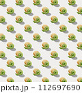 Seamless pattern of sweet rolls with green cream and soft cheese isolated on white background. 112697690