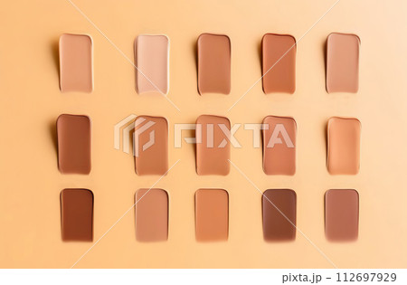 Creamy base fair tone product texture. Cosmetic face foundation smears set on beige background. Makeup swatch. Trendy self-care procedures. Textured thick cosmetics tonal cream liquid powder 112697929