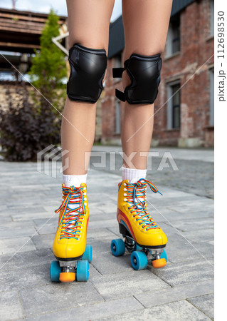 Woman trying on her new rollerblades 112698530