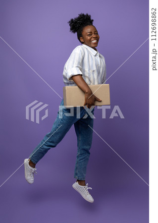 Smiling good-looking dark-skinned girl with boxes in studio Smiling good-looking dark-skinned girl with boxes in studio 112698862