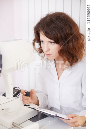 looking into eye test machine looking into eye test machine 112698963