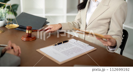 Business people and lawyer discussing contract papers sitting at the table. Concept of law, advice, legal services Business people and lawyer discussing contract papers sitting at the table. Concept of law, advice, legal services 112699192
