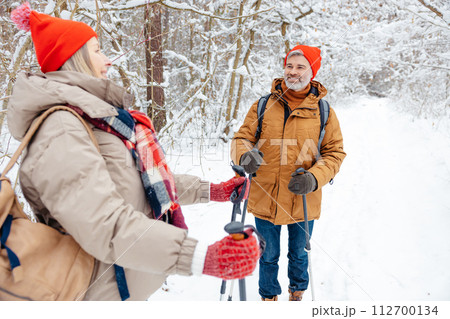 A mature couple spending good time together in a winter forest 112700134