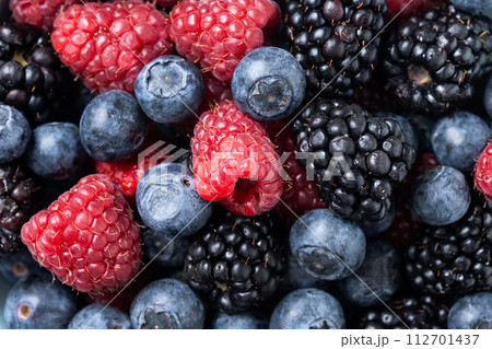 Fresh assortment berries in bowl background 112701437