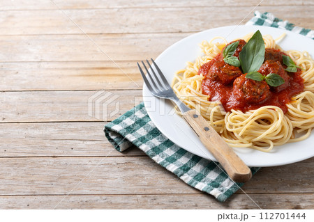 Spaghetti with meatballs on wooden table 112701444