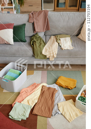 Background image of clean clothes sorted in stacks and storage boxes in home interior 112703194