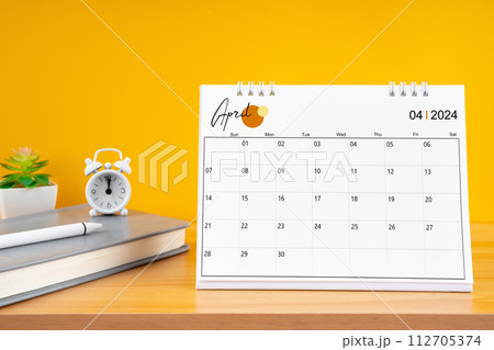 April desk calendar for 2024 year on work table. 112705374