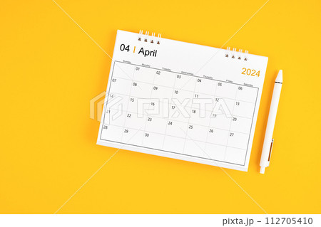 April 2024, Monthly desk calendar for 2024 year and pen. 112705410