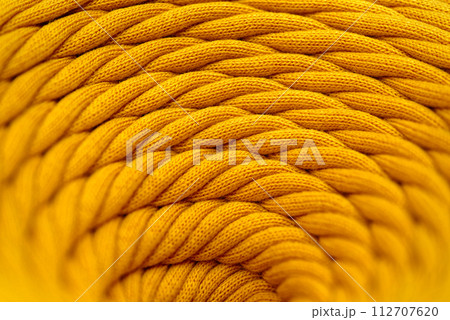 Skein of yellow braided synthetic cord, close-up shot Skein of yellow braided synthetic cord, close-up shot 112707620