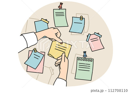 Person attach sticky notes to board 112708110