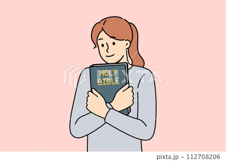 Believing woman embraces bible and feels enlightened after reading religious christian book 112708206