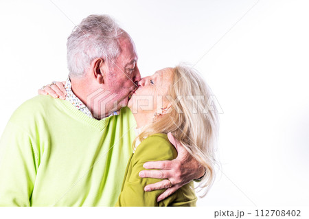 Affectionate Senior Couple Sharing a Kiss 112708402