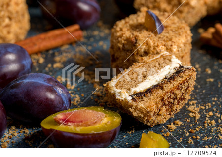 Hungarian homemade pastries. Round biscuit cakes with vanilla cream and plum jam decorated with biscuit crumbs Hungarian homemade pastries. Round biscuit cakes with vanilla cream and plum jam decorated with biscuit crumbs 112709524