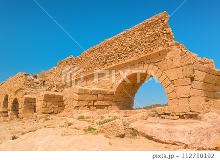 Ancient Roman aqueduct in Caesarea National Park, Israel 112710192