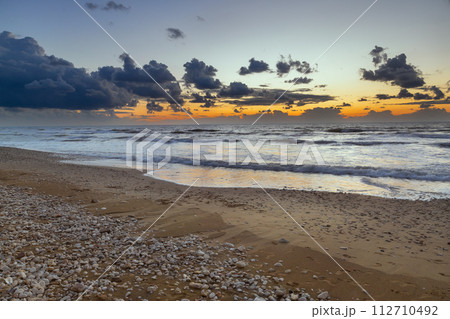 seashore with dramatic clouds at sunset in Haifa 112710492
