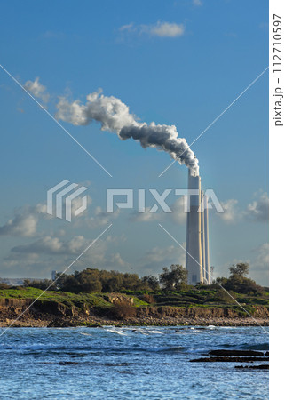chimneys of a power plant with smoke in Israel chimneys of a power plant with smoke in Israel 112710597