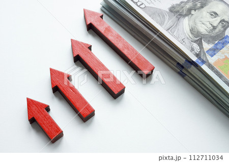 Growing graph of arrows and cash as a symbol of personal savings and income. 112711034