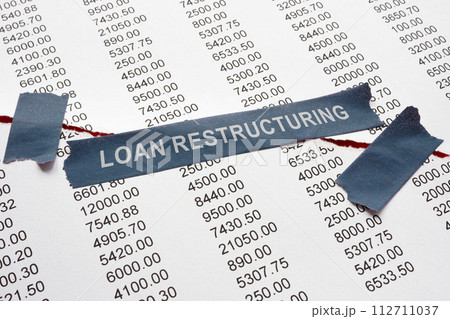 Loan restructuring concept. A torn bank document secured with tape. 112711037