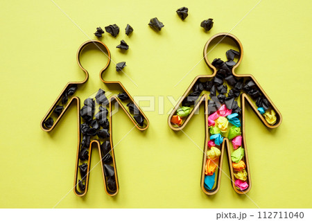 Concept of unhealthy communication, negative emotions and toxicity. Two figures with black and colored paper balls. 112711040