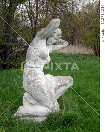 Old statue of woman after swimming in the park. Soviet monumental sculpture Old statue of woman after swimming in the park. Soviet monumental sculpture 112711236