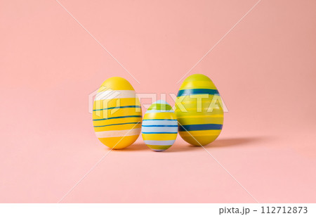 Minimal Easter layout with colorful eggs on a pink background. Easter family eggs . creative concepts. Easter card with copy space for text. Minimal Easter layout with colorful eggs on a pink background. Easter family eggs . creative concepts. Easter card with copy space for text. 112712873