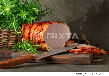 Smoked pork ham on a kitchen table. Smoked pork ham on a kitchen table. 112712989