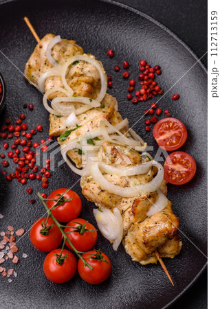 Delicious fresh chicken meat kebab with salt, spices and herbs Delicious fresh chicken meat kebab with salt, spices and herbs 112713159