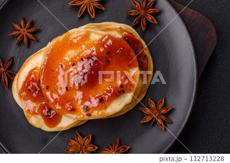 Fresh baked pancakes with delicious jam on a ceramic plate Fresh baked pancakes with delicious jam on a ceramic plate 112713228