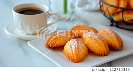 Classic French madeleine cookies, buttery and delicate, mini sponge cake baked in scallop mold Classic French madeleine cookies, buttery and delicate, mini sponge cake baked in scallop mold 112713338