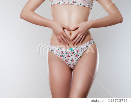 Tanned woman in top form, perfect body shape Tanned woman in top form, perfect body shape 112713735