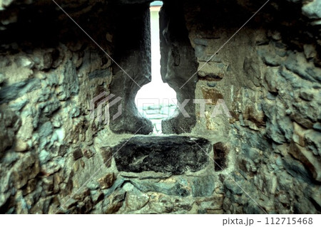 light bulb on stone wall 112715468