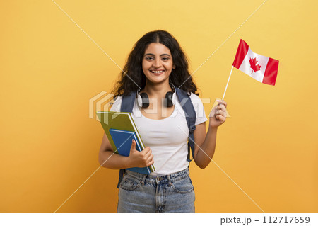 Happy student holding a Canadian flag 112717659