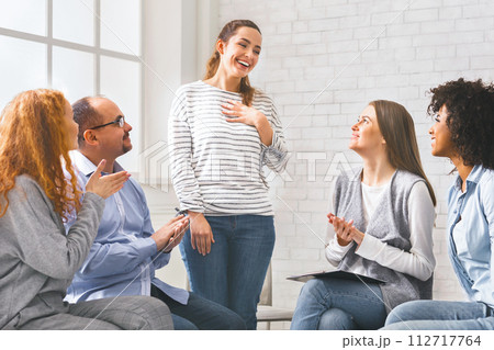 Happy welcoming woman at support group meeting, Happy welcoming woman at support group meeting, 112717764