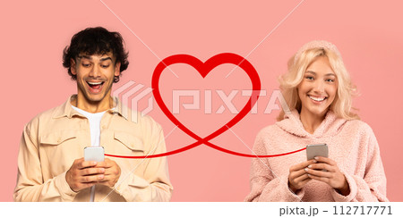 An overjoyed man in a light jacket laughs at his phone, and a delighted woman in a fuzzy pink sweater looks at hers An overjoyed man in a light jacket laughs at his phone, and a delighted woman in a fuzzy pink sweater looks at hers 112717771